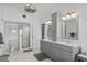 Bathroom featuring a double vanity with marble tile floors and a glass shower at 297 1St W St, Tierra Verde, FL 33715