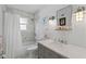 Well lit bathroom featuring marble tiling, modern fixtures, and a bathtub with shower at 297 1St W St, Tierra Verde, FL 33715