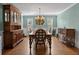 Elegant dining room with hardwood floors, stylish chandelier, and large windows that let in lots of natural light at 297 1St W St, Tierra Verde, FL 33715
