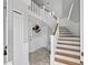 Bright entryway featuring staircase, unique decor, and neutral color palette at 297 1St W St, Tierra Verde, FL 33715