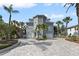 Stunning home with a circular tower, complemented by lush tropical landscaping and a large driveway at 297 1St W St, Tierra Verde, FL 33715