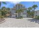 Stunning coastal home with a paver driveway, manicured landscaping, and a two-car garage at 297 1St W St, Tierra Verde, FL 33715