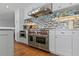 Spacious kitchen with Wolf range and stainless steel vent hood at 297 1St W St, Tierra Verde, FL 33715