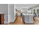 Open kitchen with light gray island, quartz countertops, and stainless appliances at 297 1St W St, Tierra Verde, FL 33715