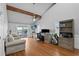 Bright living room featuring wood floors, ceiling fan, exposed beam, and sliding glass doors to a deck overlooking the water at 297 1St W St, Tierra Verde, FL 33715