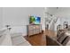 Spacious living room with hardwood floors, wainscoting, and access to staircase, creating a warm and inviting atmosphere at 297 1St W St, Tierra Verde, FL 33715