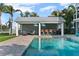 Outdoor kitchen and bar area by the pool with waterfront views at 297 1St W St, Tierra Verde, FL 33715