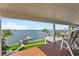 Beautiful deck with seating overlooking lush landscaping and the bay at 297 1St W St, Tierra Verde, FL 33715