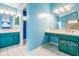 A large bathroom with double sinks, bright blue walls, and ample counter space at 3013 Crest Dr, Clearwater, FL 33759
