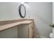 Neutral bathroom featuring an oval mirror above the vanity, offering practical space at 3013 Crest Dr, Clearwater, FL 33759