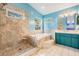 Bathroom featuring soaking tub and walk in shower with travertine tile at 3013 Crest Dr, Clearwater, FL 33759