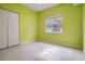 Bedroom with tile floors, green walls, and a large window at 3013 Crest Dr, Clearwater, FL 33759