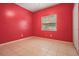 Bedroom with tile floors, red walls, and a window at 3013 Crest Dr, Clearwater, FL 33759