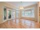 Bright dining room area with tile flooring, bay windows, and French doors leading to the backyard at 3013 Crest Dr, Clearwater, FL 33759