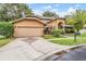 Well-maintained home with a two-car garage, mature landscaping, and a brick-paved driveway leading to the front entrance at 3013 Crest Dr, Clearwater, FL 33759