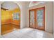 Bright entryway with decorative doors, tile floors and view into the living area at 3013 Crest Dr, Clearwater, FL 33759