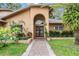 Close up of the entry to a home with beautiful landscaping and brick walkway at 3013 Crest Dr, Clearwater, FL 33759