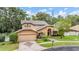 Stunning exterior view featuring a meticulously maintained lawn, landscaped yard, and an attached two-car garage at 3013 Crest Dr, Clearwater, FL 33759