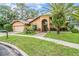 Charming home with lush landscaping, inviting front entrance, and attached two-car garage on a well-manicured lawn at 3013 Crest Dr, Clearwater, FL 33759