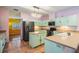 Bright kitchen with tiled floor, light-colored cabinets and stainless steel appliances at 3013 Crest Dr, Clearwater, FL 33759
