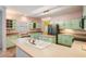 Spacious kitchen featuring ample counter space, light green cabinets, and modern appliances at 3013 Crest Dr, Clearwater, FL 33759
