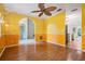 Spacious living room with wood floors, arched entryway, and unique light fixtures at 3013 Crest Dr, Clearwater, FL 33759