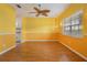 Sunny living room featuring wood floors, crown molding, and a unique ceiling fan at 3013 Crest Dr, Clearwater, FL 33759