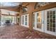 Outdoor patio with brick flooring, complemented by white French doors at 3013 Crest Dr, Clearwater, FL 33759