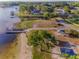 Beautiful aerial view of waterfront community, showcasing boat docks and access for water activities and relaxation at 3047 Lake Padgett Dr, Land O Lakes, FL 34639