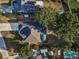 Overhead view of property, with outdoor pool and mature trees at 3047 Lake Padgett Dr, Land O Lakes, FL 34639