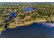 Picturesque aerial view of lakefront community, featuring waterways, private beaches, and established homes at 3047 Lake Padgett Dr, Land O Lakes, FL 34639