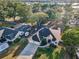 Stunning aerial view of the home featuring a well-maintained lawn, ample parking, and manicured landscaping at 3047 Lake Padgett Dr, Land O Lakes, FL 34639