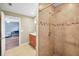 Shower and partial view of updated bathroom with tan tile in home at 3047 Lake Padgett Dr, Land O Lakes, FL 34639