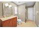 Neutral bathroom with a wood vanity and decorative framed mirror at 3047 Lake Padgett Dr, Land O Lakes, FL 34639