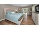 Calm bedroom with wood floors, sliding door, and stylish furnishings provides a peaceful retreat at 3047 Lake Padgett Dr, Land O Lakes, FL 34639