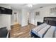 A bright bedroom featuring wood-look floors and multiple access doors at 3047 Lake Padgett Dr, Land O Lakes, FL 34639