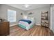 Comfortable bedroom with wood floors, a double bed, and nautical-themed decorations at 3047 Lake Padgett Dr, Land O Lakes, FL 34639