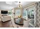 Dining area with views of the pool and an adjacent fireplace and TV area at 3047 Lake Padgett Dr, Land O Lakes, FL 34639