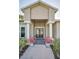 Welcoming front entrance with double doors, decorative columns, and tasteful landscaping at 3047 Lake Padgett Dr, Land O Lakes, FL 34639