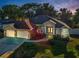 Beautiful home with well-manicured front yard and three-car garage, situated on a landscaped lot at 3047 Lake Padgett Dr, Land O Lakes, FL 34639