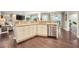 Open kitchen features stainless appliances and granite countertops with a view of the Gathering room at 3047 Lake Padgett Dr, Land O Lakes, FL 34639