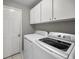 Bright laundry room with white cabinets and modern washer and dryer at 3047 Lake Padgett Dr, Land O Lakes, FL 34639