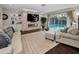 Open living area with fireplace, built-in shelving, and access to the screened lanai with pool at 3047 Lake Padgett Dr, Land O Lakes, FL 34639