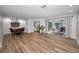 Expansive living room featuring modern floors, dining area, and seamless flow to the outdoor patio at 3047 Lake Padgett Dr, Land O Lakes, FL 34639