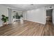 Bright, open living area with sliding glass doors leading to the outdoor patio, enhanced by modern flooring at 3047 Lake Padgett Dr, Land O Lakes, FL 34639