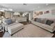 Bright living room with hardwood floors, comfortable seating, and an open view into the kitchen area at 3047 Lake Padgett Dr, Land O Lakes, FL 34639