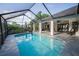 Outdoor pool in screened enclosure, with adjacent covered patio at 3047 Lake Padgett Dr, Land O Lakes, FL 34639