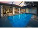 A sparkling pool surrounded by a screened-in patio, perfect for outdoor entertaining and relaxation at 3047 Lake Padgett Dr, Land O Lakes, FL 34639