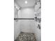 Modern bathroom featuring a walk-in shower with pebble floor and tiled walls at 3047 Lake Padgett Dr, Land O Lakes, FL 34639