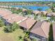 Picturesque aerial view showcasing a lakeside community with tile-roofed houses and scenic landscaping on a bright sunny day at 310 Cedar Falls Dr, Apollo Beach, FL 33572